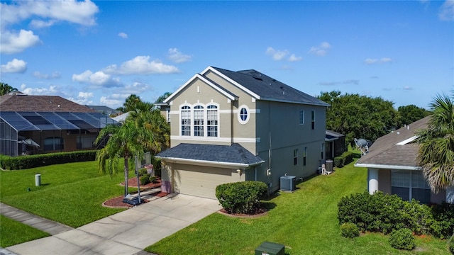 2530 The Oaks Blvd, Kissimmee, FL 34746 - view of front facade featuring stucco siding, a garage, driveway, and a front lawn