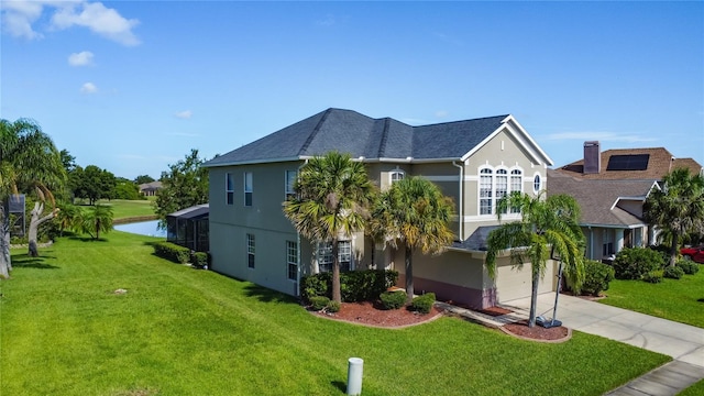 2530 The Oaks Blvd, Kissimmee, FL 34746 - view of front of house with concrete driveway, stucco siding, a garage, and a front yard