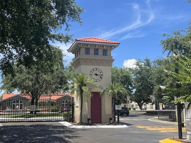 2770 Club Cortile Cir Unit A, Kissimmee, FL 34746 - exterior view of a gate and stucco siding