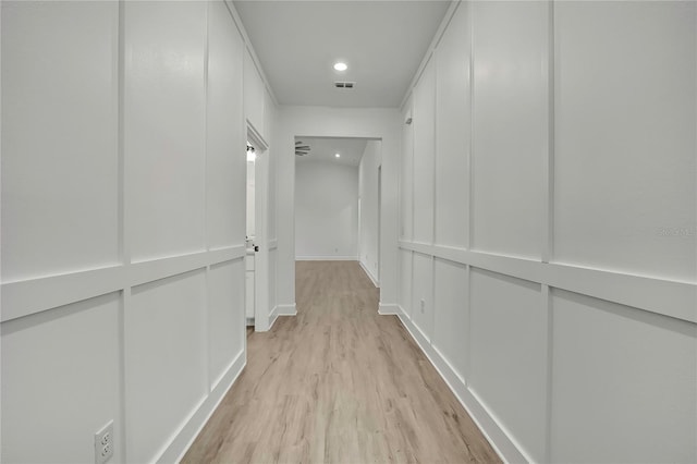 9739 Loretto St, Spring Hill, FL 34608 - hall with light wood-type flooring, recessed lighting, and a decorative wall
