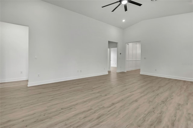 9739 Loretto St, Spring Hill, FL 34608 - empty room with a ceiling fan, high vaulted ceiling, and light wood-style flooring