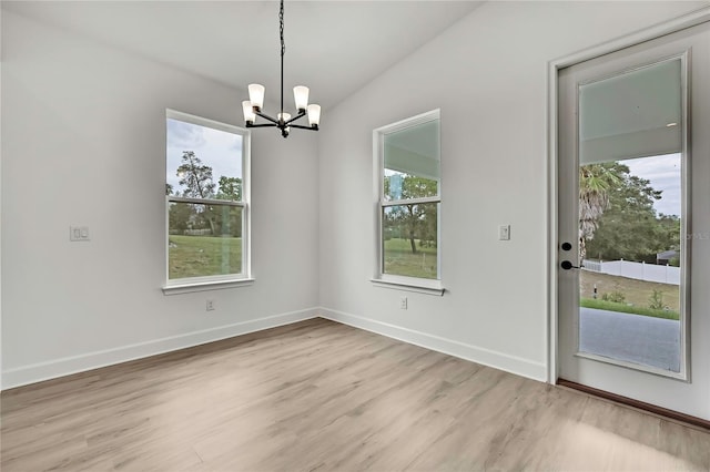 9739 Loretto St, Spring Hill, FL 34608 - unfurnished dining area with light wood-style floors and a chandelier