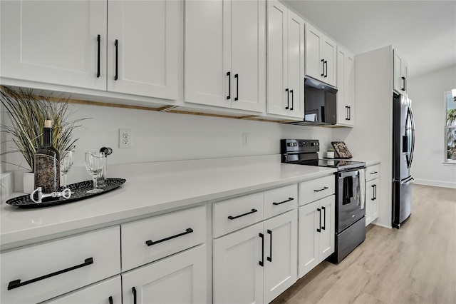 9739 Loretto St, Spring Hill, FL 34608 - kitchen with black electric range, stainless steel refrigerator with ice dispenser, white cabinetry, light wood-type flooring, and light countertops