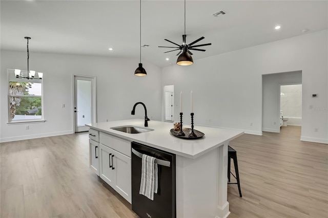 9739 Loretto St, Spring Hill, FL 34608 - kitchen featuring black dishwasher, open floor plan, light wood-type flooring, hanging light fixtures, and light countertops