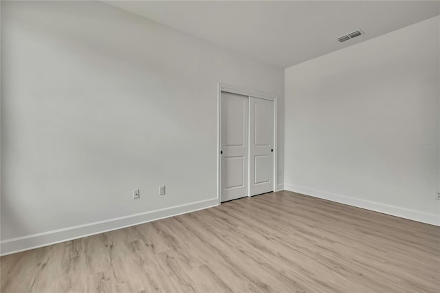 9739 Loretto St, Spring Hill, FL 34608 - unfurnished bedroom with light wood-style flooring and a closet