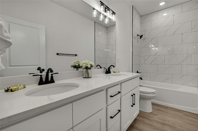 9739 Loretto St, Spring Hill, FL 34608 - bathroom featuring double vanity, wood finished floors, washtub / shower combination, and recessed lighting