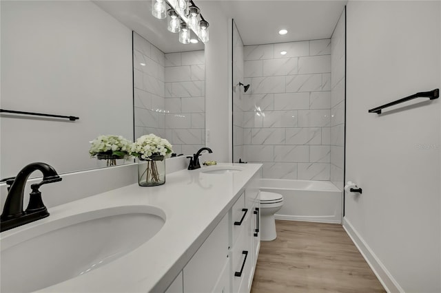 9739 Loretto St, Spring Hill, FL 34608 - full bathroom featuring double vanity, wood finished floors, recessed lighting, and shower / bathtub combination