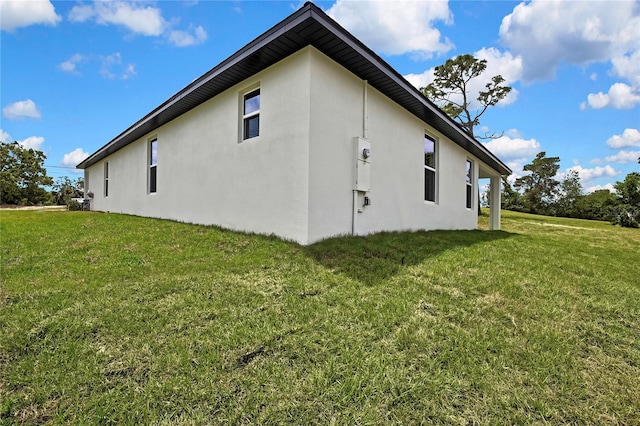 9739 Loretto St, Spring Hill, FL 34608 - view of home's exterior with stucco siding and a lawn