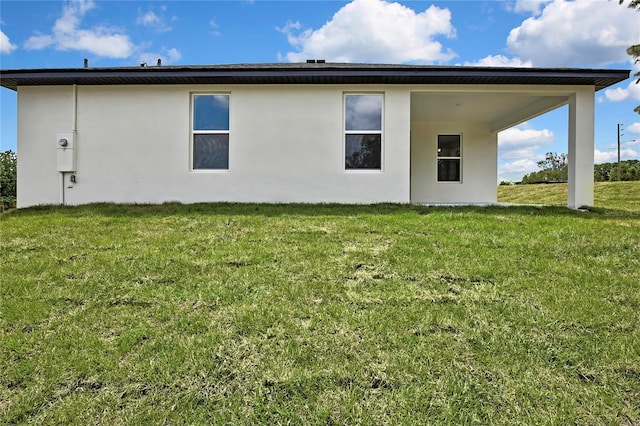 9739 Loretto St, Spring Hill, FL 34608 - back of property featuring stucco siding and a yard