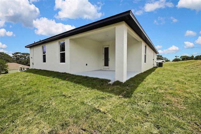 9739 Loretto St, Spring Hill, FL 34608 - rear view of property with stucco siding, a patio area, and a lawn