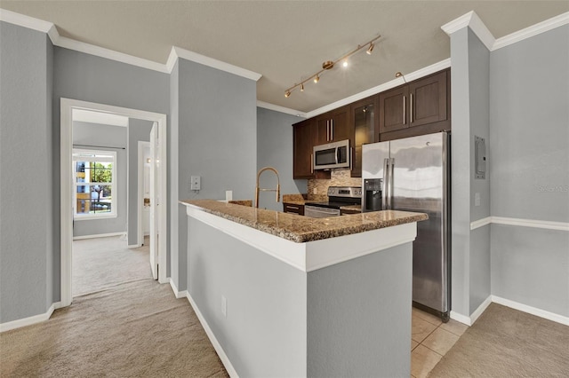 3757 Conroy Rd Unit 2525, Orlando, FL 32839 - kitchen with appliances with stainless steel finishes, dark brown cabinets, ornamental molding, decorative backsplash, and light colored carpet