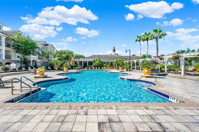 3757 Conroy Rd Unit 2525, Orlando, FL 32839 - community pool featuring a patio and a residential view