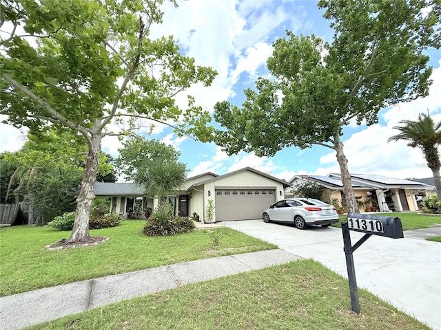 11310 Darlington Dr, Orlando, FL 32837 - ranch-style home featuring an attached garage, a front lawn, concrete driveway, and stucco siding
