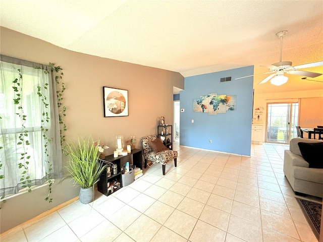11310 Darlington Dr, Orlando, FL 32837 - living room featuring a ceiling fan, light tile patterned flooring, a textured ceiling, and lofted ceiling