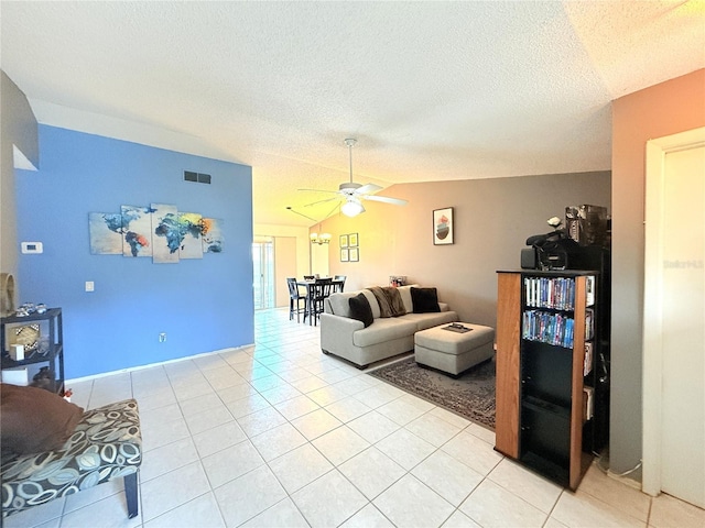 11310 Darlington Dr, Orlando, FL 32837 - living room featuring a ceiling fan, a textured ceiling, light tile patterned floors, and vaulted ceiling
