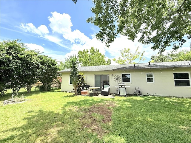 11310 Darlington Dr, Orlando, FL 32837 - back of house with a yard and concrete block siding