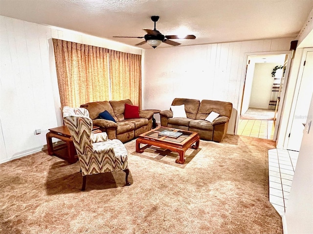 8547 Cedar Cove Dr, Orlando, FL 32819 - carpeted living room featuring ceiling fan, wood walls, and a textured ceiling