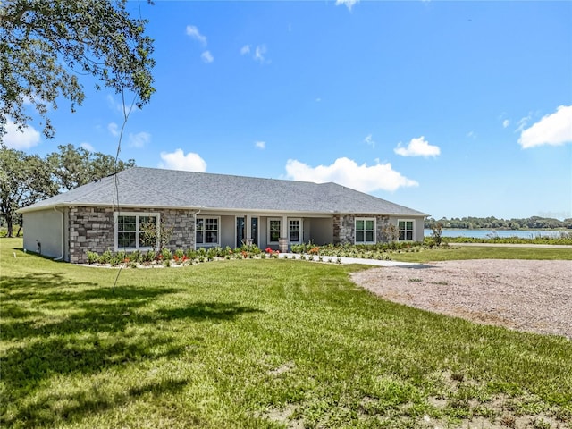 14243 County Road 450, Umatilla, FL 32784 - ranch-style house featuring stone siding, a water view, and a front lawn