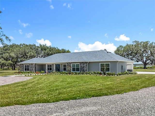 14243 County Road 450, Umatilla, FL 32784 - single story home with a garage, stucco siding, a front lawn, and stone siding