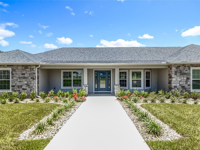 14243 County Road 450, Umatilla, FL 32784 - property entrance featuring stucco siding, stone siding, roof with shingles, and a lawn