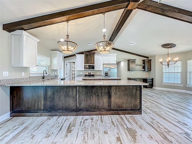 14243 County Road 450, Umatilla, FL 32784 - kitchen featuring stainless steel appliances, a chandelier, light wood-style flooring, and white cabinets