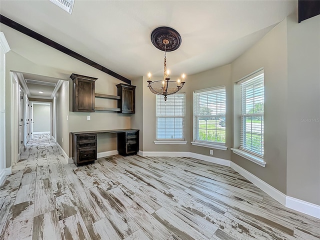 14243 County Road 450, Umatilla, FL 32784 - unfurnished dining area with lofted ceiling, built in study area, light wood finished floors, and a chandelier