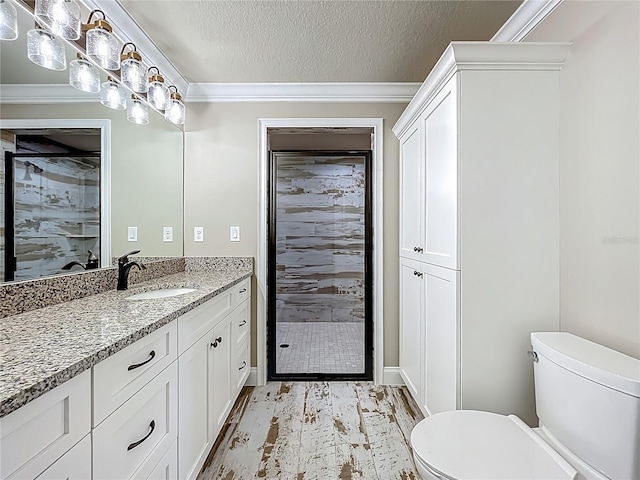 14243 County Road 450, Umatilla, FL 32784 - bathroom featuring vanity, a stall shower, a textured ceiling, wood finished floors, and ornamental molding