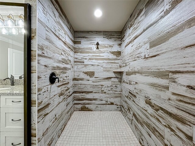 14243 County Road 450, Umatilla, FL 32784 - bathroom featuring a tile shower, wood walls, vanity, and tile patterned flooring