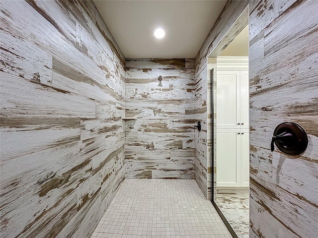 14243 County Road 450, Umatilla, FL 32784 - bathroom with wood walls, tiled shower, and tile patterned floors