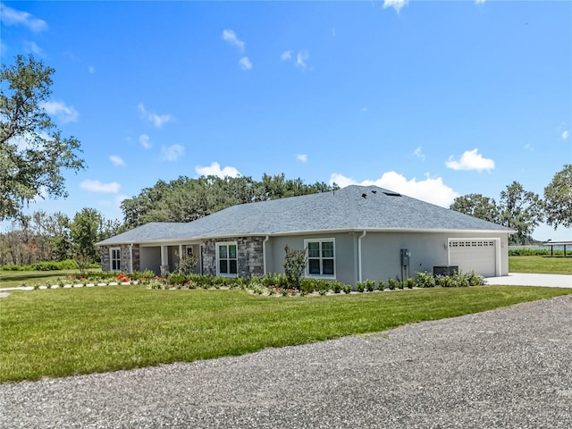14243 County Road 450, Umatilla, FL 32784 - view of front of house featuring an attached garage, stucco siding, a front yard, and driveway