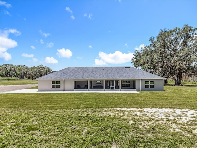 14243 County Road 450, Umatilla, FL 32784 - rear view of property featuring a sunroom, a lawn, and stucco siding