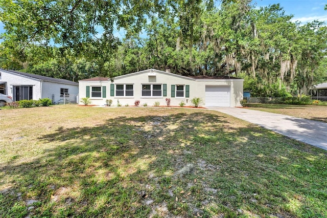 1506 S Elliott St, Sanford, FL 32771 - view of front of home featuring driveway, an attached garage, stucco siding, and view of scattered trees