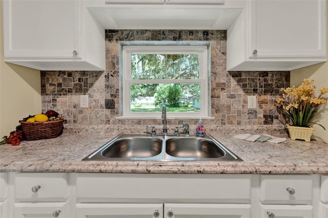 1506 S Elliott St, Sanford, FL 32771 - kitchen featuring white cabinetry, tasteful backsplash, and light countertops