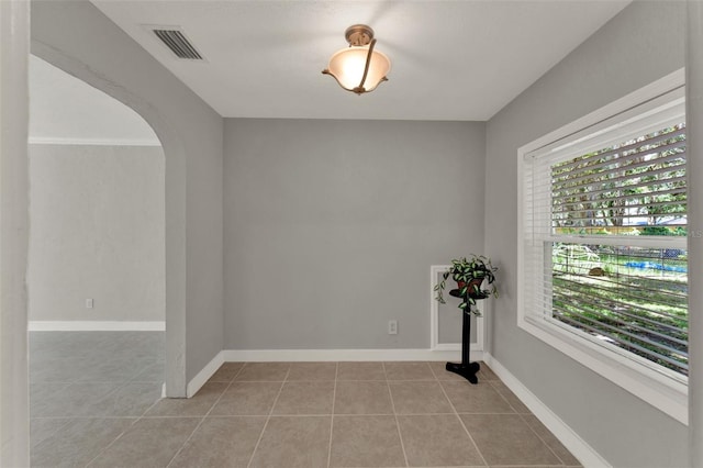 1506 S Elliott St, Sanford, FL 32771 - empty room featuring light tile patterned floors and arched walkways