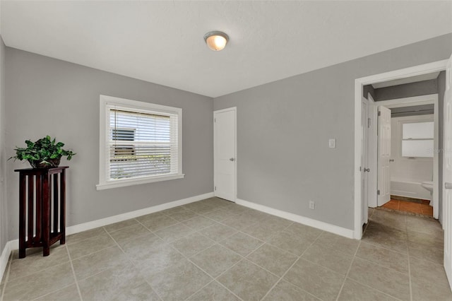 1506 S Elliott St, Sanford, FL 32771 - empty room featuring light tile patterned flooring and baseboards