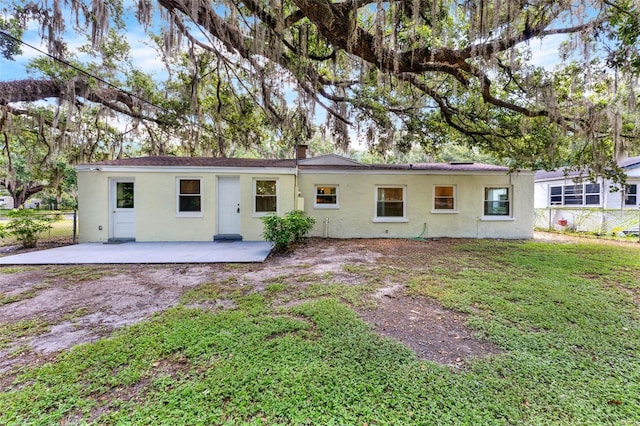 1506 S Elliott St, Sanford, FL 32771 - back of property with a patio area, stucco siding, and a chimney