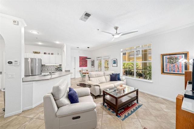 860 N Orange Ave Unit 210, Orlando, FL 32801 - living room featuring a ceiling fan, arched walkways, light tile patterned floors, recessed lighting, and crown molding
