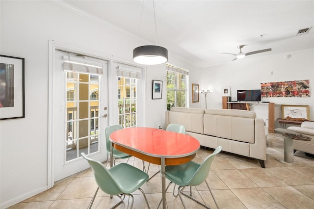 860 N Orange Ave Unit 210, Orlando, FL 32801 - dining space featuring light tile patterned floors, crown molding, french doors, and a ceiling fan