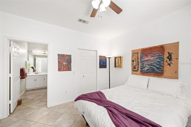 860 N Orange Ave Unit 210, Orlando, FL 32801 - bedroom featuring light tile patterned flooring, ensuite bath, and a ceiling fan