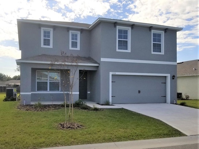 5157 Masser Rd, Saint Cloud, FL 34772 - traditional-style home featuring stucco siding, driveway, a front yard, and a garage