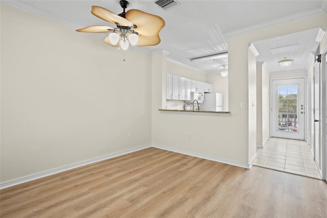 660 Celebration Ave Unit 250, Kissimmee, FL 34747 - unfurnished living room with a ceiling fan, light wood-style floors, and crown molding