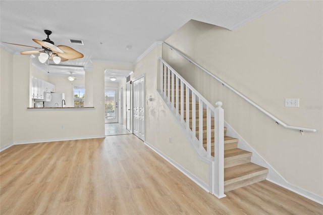 660 Celebration Ave Unit 250, Kissimmee, FL 34747 - stairway featuring a ceiling fan, ornamental molding, and wood finished floors