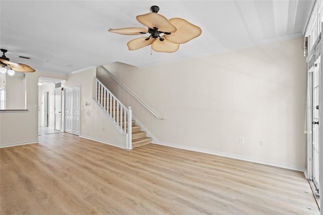 660 Celebration Ave Unit 250, Kissimmee, FL 34747 - unfurnished living room featuring ceiling fan, ornamental molding, stairway, and light wood-style flooring