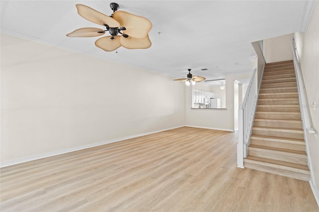 660 Celebration Ave Unit 250, Kissimmee, FL 34747 - unfurnished living room with ceiling fan, stairway, and light wood-style flooring