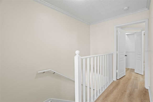 660 Celebration Ave Unit 250, Kissimmee, FL 34747 - hallway featuring an upstairs landing, ornamental molding, wood finished floors, and a textured ceiling
