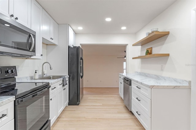 235 Ruth Blvd, Longwood, FL 32750 - kitchen with black appliances, light wood finished floors, white cabinets, open shelves, and recessed lighting