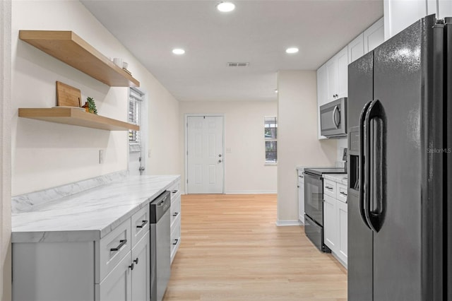 235 Ruth Blvd, Longwood, FL 32750 - kitchen featuring black appliances, light wood-style flooring, recessed lighting, open shelves, and white cabinets