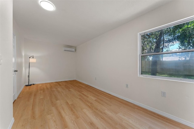 235 Ruth Blvd, Longwood, FL 32750 - unfurnished room with an AC wall unit and light wood-style flooring