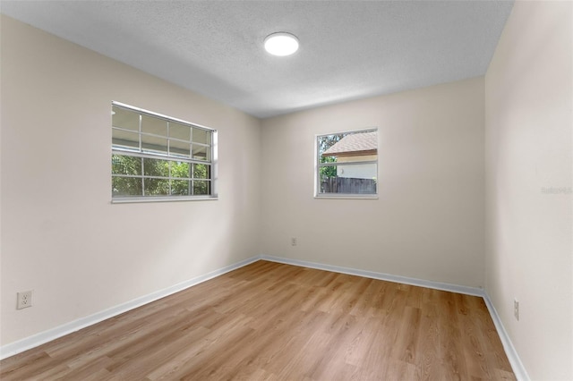 235 Ruth Blvd, Longwood, FL 32750 - empty room with healthy amount of natural light, light wood-style floors, and a textured ceiling