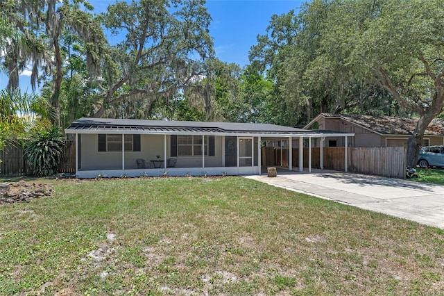 235 Ruth Blvd, Longwood, FL 32750 - view of front facade with concrete driveway, a sunroom, and an attached carport